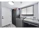 Spacious laundry room with modern machines and ample storage, ready for convenience at 5020 E Dallas St, Mesa, AZ 85205