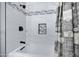 A modern shower featuring updated tiling, sleek fixtures, and a built-in niche at 5020 E Dallas St, Mesa, AZ 85205