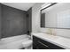 Bathroom featuring a tiled shower, modern vanity with gold hardware, and updated fixtures at 520 N Stapley Dr # 166, Mesa, AZ 85203