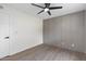 Bedroom featuring paneled accent wall, modern ceiling fan, and sleek door hardware at 520 N Stapley Dr # 166, Mesa, AZ 85203