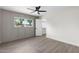Bedroom with spacious closet, decorative wall paneling, and bright window at 520 N Stapley Dr # 166, Mesa, AZ 85203