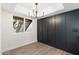 Dining area with a view of the outside stairs, modern chandelier and sleek black panel wall at 520 N Stapley Dr # 166, Mesa, AZ 85203