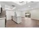Kitchen area with white cabinets, quartz countertops, stainless steel appliances, and access to a spacious living area at 520 N Stapley Dr # 166, Mesa, AZ 85203