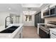 Bright kitchen with a stainless steel oven, and microwave, stylish white cabinets and countertops, and view of adjacent room at 520 N Stapley Dr # 166, Mesa, AZ 85203