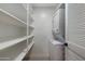 Bright laundry room with white shelves and a stacked washer and dryer combo at 520 N Stapley Dr # 166, Mesa, AZ 85203