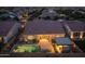 Aerial view of a home featuring a pool, patio, and outdoor kitchen at dusk at 5250 S Wesley Cir, Mesa, AZ 85212