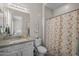 Well-lit bathroom features a granite vanity, decorative shower curtain, and stylish decor at 5250 S Wesley Cir, Mesa, AZ 85212