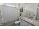 Well-lit bathroom featuring a granite countertop and stylish shower curtain at 5250 S Wesley Cir, Mesa, AZ 85212