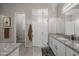 Bright bathroom with granite vanity, glass shower, and tile floors, showcasing modern design at 5250 S Wesley Cir, Mesa, AZ 85212