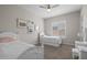 Charming bedroom showcases two white beds with a clean, bright design and a ceiling fan at 5250 S Wesley Cir, Mesa, AZ 85212