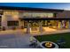 Outdoor patio featuring a cozy fire pit, comfortable seating, and a lush green lawn, perfect for evening gatherings at 5250 S Wesley Cir, Mesa, AZ 85212