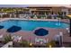 A breathtaking community pool, complete with lounge areas, umbrellas, and a splash fountain, perfect for recreation at 5250 S Wesley Cir, Mesa, AZ 85212