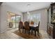 Elegant dining room featuring a stylish table and chairs, with a sliding glass door leading to an outdoor patio at 5250 S Wesley Cir, Mesa, AZ 85212