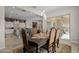 Formal dining room open to kitchen features wood floors, stylish table, and sliding glass door at 5250 S Wesley Cir, Mesa, AZ 85212
