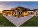 An exterior view of the clubhouse, featuring modern architecture, stone accents, and beautifully landscaped grounds at 5250 S Wesley Cir, Mesa, AZ 85212