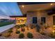 Landscaped exterior view showcasing desert flora, stone accents, and a modern architectural design, blending elegance with natural beauty at 5250 S Wesley Cir, Mesa, AZ 85212