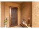Stylish front entrance with an ornate metal security door and charming décor, adding curb appeal and security at 5250 S Wesley Cir, Mesa, AZ 85212