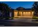 Inviting home with a well-kept lawn, mature trees, and a paved driveway leading to a three-car garage at 5250 S Wesley Cir, Mesa, AZ 85212