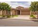 Beautifully landscaped home with a two-car garage, vibrant greenery, and a well-manicured lawn at 5250 S Wesley Cir, Mesa, AZ 85212