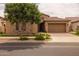 Charming single-story home featuring a lush front yard with a well-manicured lawn and desert landscaping at 5250 S Wesley Cir, Mesa, AZ 85212