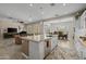 Stylish kitchen island with granite countertops, pendant lighting, and seating, flowing into the living and dining areas at 5250 S Wesley Cir, Mesa, AZ 85212