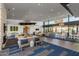 Expansive resident lounge featuring modern decor, comfortable seating, stylish lighting, and floor to ceiling windows at 5250 S Wesley Cir, Mesa, AZ 85212