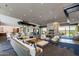 Spacious lounge with modern decor, stylish seating, stone fireplace, and views at 5250 S Wesley Cir, Mesa, AZ 85212
