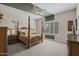 Spacious main bedroom boasts neutral tones, a four-poster bed, and large windows with shutters at 5250 S Wesley Cir, Mesa, AZ 85212