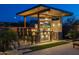Inviting backyard bar setup with covered seating, outdoor television, grill, and mini-fridge for entertaining at 5250 S Wesley Cir, Mesa, AZ 85212