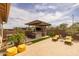 Beautifully designed outdoor kitchen area featuring a built-in grill, bar seating, and a hot tub at 5250 S Wesley Cir, Mesa, AZ 85212
