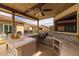 Covered outdoor kitchen with a built-in grill, stainless steel appliances, and ample counter space for meal preparation at 5250 S Wesley Cir, Mesa, AZ 85212
