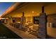 Covered patio with stone columns, fireplace, comfortable seating and sunset views at 5250 S Wesley Cir, Mesa, AZ 85212