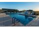 Community pool with tiled pool bottom and handrails with shade structures near clubhouse at 5250 S Wesley Cir, Mesa, AZ 85212