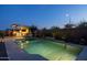 Backyard featuring a sparkling pool, outdoor kitchen area, and lush landscaping, creating a private oasis at 5250 S Wesley Cir, Mesa, AZ 85212