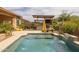 Beautiful pool area featuring an outdoor kitchen with a covered bar and lounge chairs with a yellow umbrella at 5250 S Wesley Cir, Mesa, AZ 85212