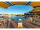 Community pool features a splash fountain and sunshades with seating and lounge chairs at 5250 S Wesley Cir, Mesa, AZ 85212