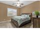 Bright bedroom featuring a ceiling fan, shutters, and dark furniture at 5342 S Citrus Ct, Gilbert, AZ 85298