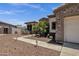 Landscaped front yard with desert flora, leading up to a welcoming home with stone and stucco accents at 5342 S Citrus Ct, Gilbert, AZ 85298