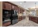 Kitchen showcasing stainless steel appliances, dark cabinetry, and tile flooring at 5342 S Citrus Ct, Gilbert, AZ 85298