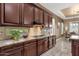 Kitchen counter and cabinets with granite countertops and a tile backsplash at 5342 S Citrus Ct, Gilbert, AZ 85298