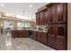 Functional kitchen with dark wood cabinetry, granite counters, and modern appliances at 5342 S Citrus Ct, Gilbert, AZ 85298