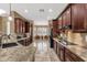 Open-concept kitchen with dark cabinets, granite counters, and views to the adjacent breakfast nook at 5342 S Citrus Ct, Gilbert, AZ 85298