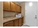 Well-lit laundry room with ample cabinetry and folding space and a decorative 'Laundry' sign at 5342 S Citrus Ct, Gilbert, AZ 85298