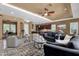 Spacious living room featuring neutral decor, ceiling fan, and open floor plan with ample seating at 5342 S Citrus Ct, Gilbert, AZ 85298