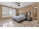 This bedroom features a ceiling fan, shutters, and neutral colors at 5342 S Citrus Ct, Gilbert, AZ 85298