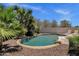 Backyard pool surrounded by desert landscaping with water feature and lounge chairs at 5342 S Citrus Ct, Gilbert, AZ 85298