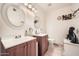 Bright bathroom boasts double sinks and a tub/shower, offering a functional space at 6304 N 47Th Ave, Glendale, AZ 85301