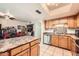 Well-equipped kitchen with stainless steel appliances and wood cabinetry at 6304 N 47Th Ave, Glendale, AZ 85301