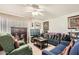 Cozy living room features neutral tile flooring, ceiling fan, and comfortable seating at 6304 N 47Th Ave, Glendale, AZ 85301