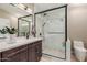 Bathroom showcasing glass enclosed shower with hexagon tile floor, single sink vanity with white countertops at 6357 W Potter Dr, Glendale, AZ 85308
